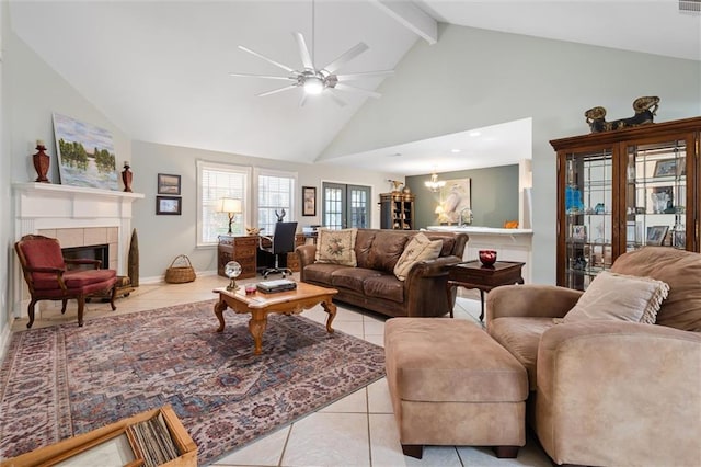 tiled living room featuring a tiled fireplace, high vaulted ceiling, ceiling fan, and beamed ceiling