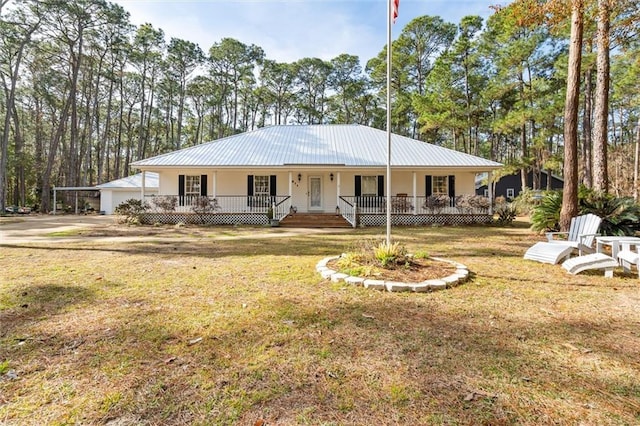 single story home featuring a carport, covered porch, and a front lawn