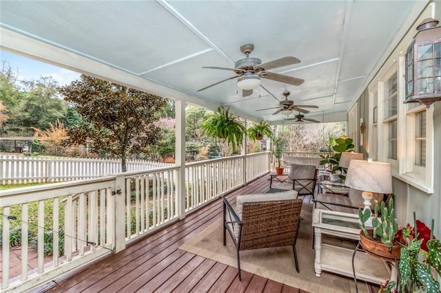 wooden deck featuring a ceiling fan and fence