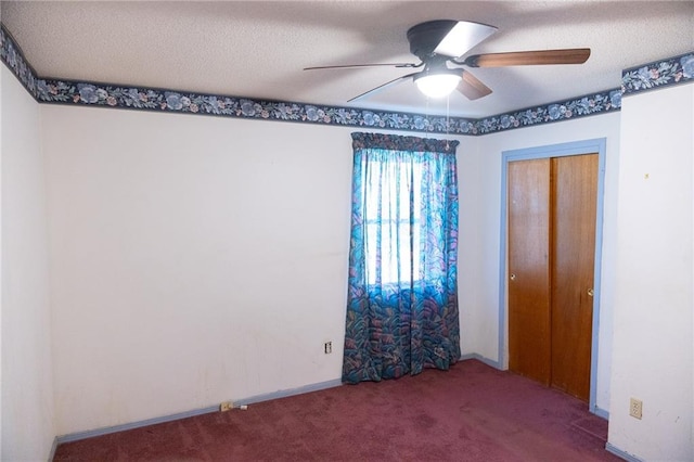 unfurnished bedroom with a textured ceiling, ceiling fan, carpet, and a closet