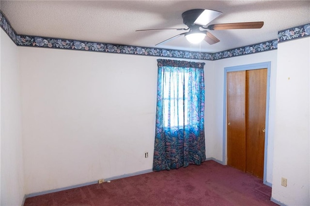 unfurnished bedroom with a textured ceiling, ceiling fan, a closet, and carpet floors