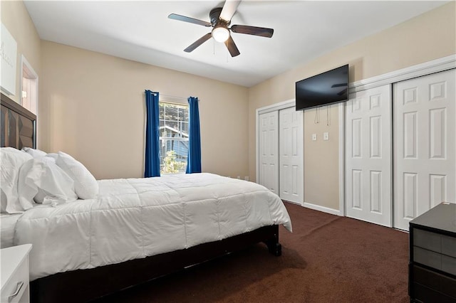 carpeted bedroom with multiple closets and ceiling fan