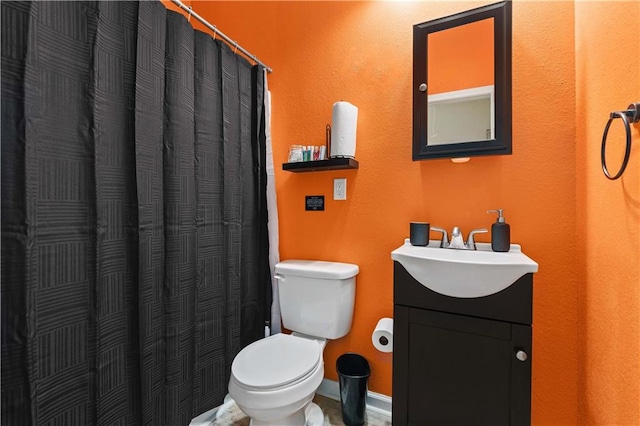 bathroom featuring vanity, toilet, and a shower with shower curtain