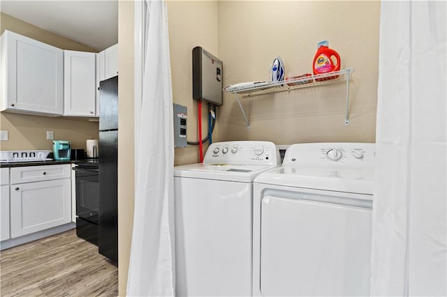 laundry room featuring light hardwood / wood-style flooring and washer and dryer