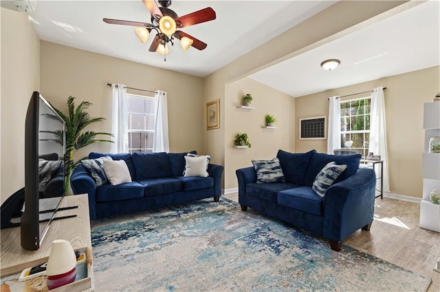 living room with ceiling fan and hardwood / wood-style floors