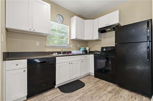 kitchen with black appliances, sink, light wood-type flooring, and white cabinetry