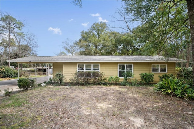 single story home with driveway and an attached carport