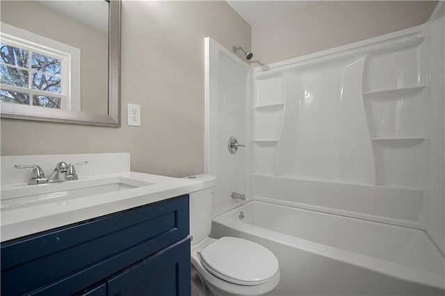 bathroom featuring bathtub / shower combination, vanity, and toilet