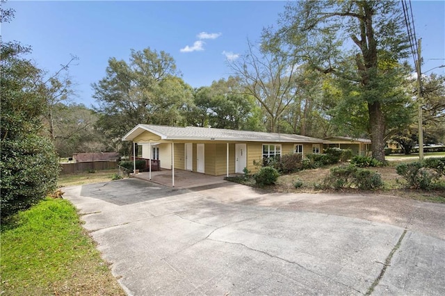 single story home featuring an attached carport and driveway