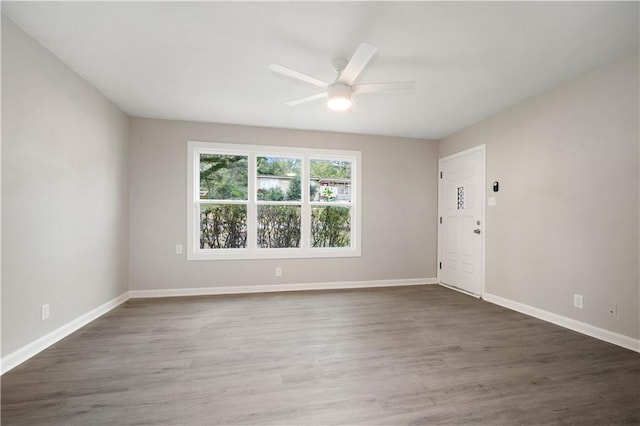 unfurnished room with ceiling fan, baseboards, and wood finished floors