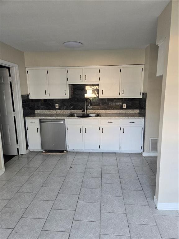 kitchen with dishwasher, backsplash, white cabinets, and sink