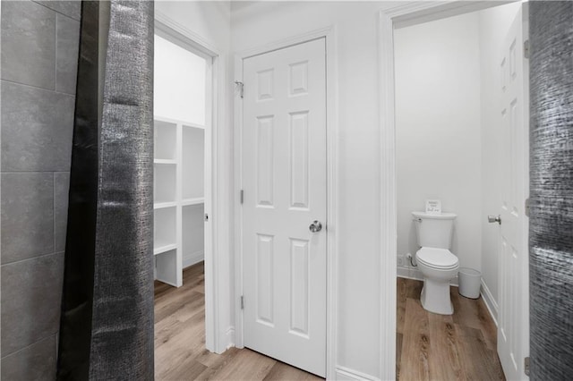 bathroom with hardwood / wood-style floors and toilet