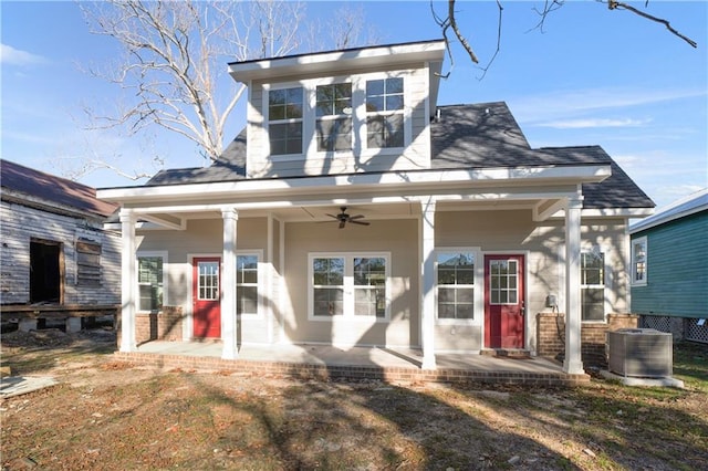 view of front of property with a front lawn, ceiling fan, a patio, and central AC