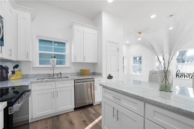 kitchen featuring stove, dark hardwood / wood-style flooring, sink, dishwasher, and white cabinetry