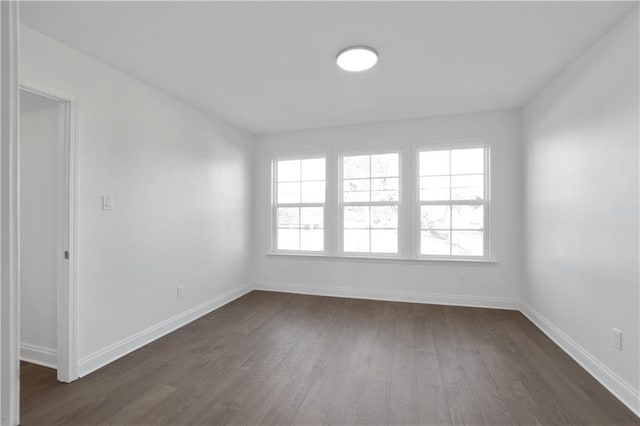 empty room with dark hardwood / wood-style floors