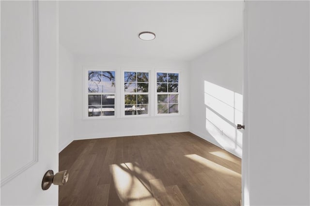 spare room with dark hardwood / wood-style flooring