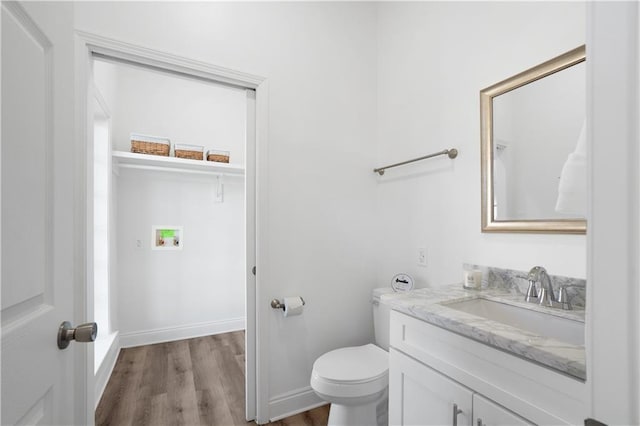 bathroom featuring hardwood / wood-style flooring, vanity, and toilet