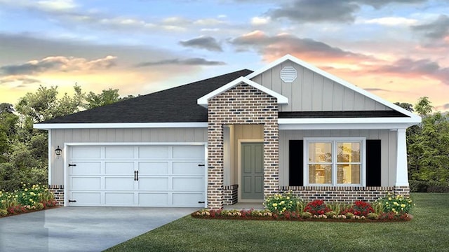 view of front of house with a garage and a yard