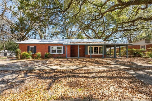 ranch-style house with an attached carport and brick siding