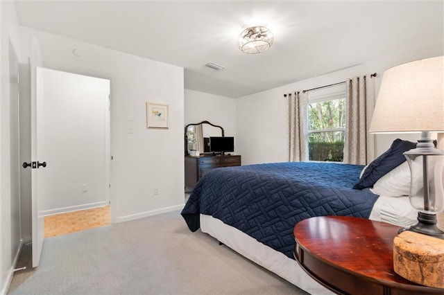 bedroom with light colored carpet