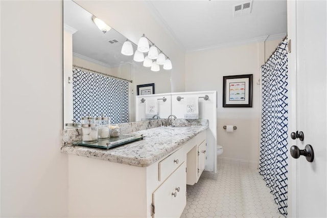 bathroom with vanity, toilet, and ornamental molding