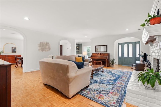 living room with a fireplace and light parquet floors