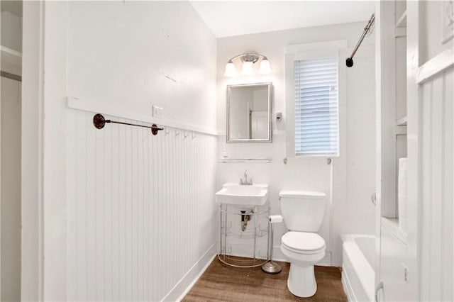 2014 Bakers Ln, Mobile, AL 36605 - full bathroom with a washtub, toilet, wood finished floors, a shower, and a sink