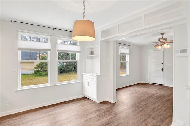 2014 Bakers Ln, Mobile, AL 36605 - unfurnished dining area featuring ceiling fan, baseboards, and wood finished floors