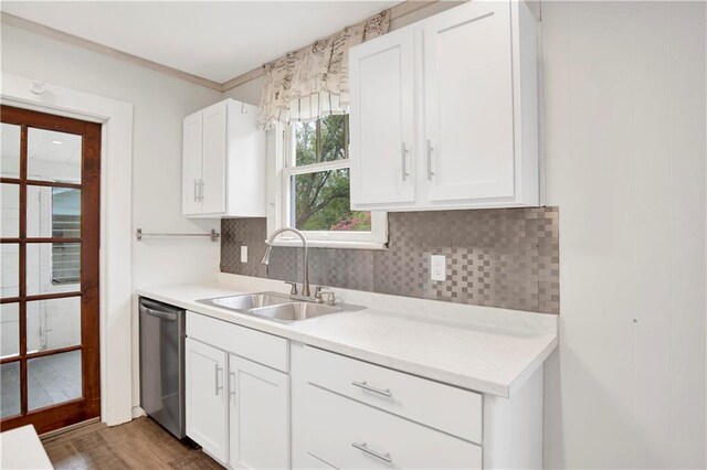 2014 Bakers Ln, Mobile, AL 36605 - kitchen with a sink, white cabinetry, dishwasher, and light countertops