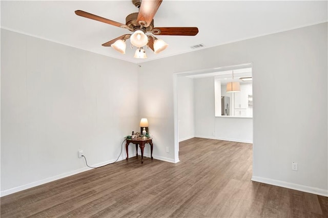 2014 Bakers Ln, Mobile, AL 36605 - unfurnished room with wood finished floors, a ceiling fan, and baseboards