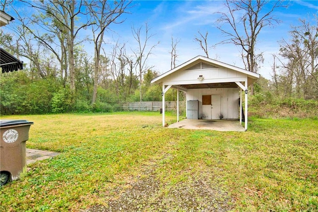 2014 Bakers Ln, Mobile, AL 36605 - view of yard featuring an attached carport, driveway, an outdoor structure, and fence