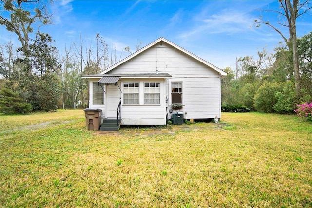 2014 Bakers Ln, Mobile, AL 36605 - back of property featuring a lawn, cooling unit, and entry steps