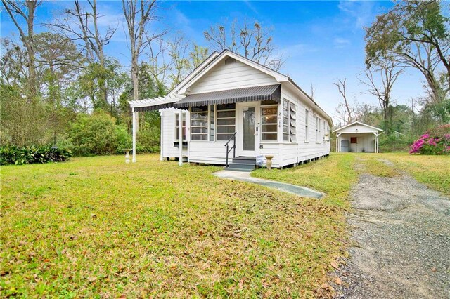 2014 Bakers Ln, Mobile, AL 36605 - view of front of property featuring a detached carport, a front lawn, entry steps, an outdoor structure, and driveway