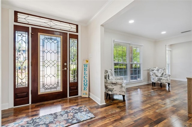 entryway with dark hardwood / wood-style flooring and crown molding