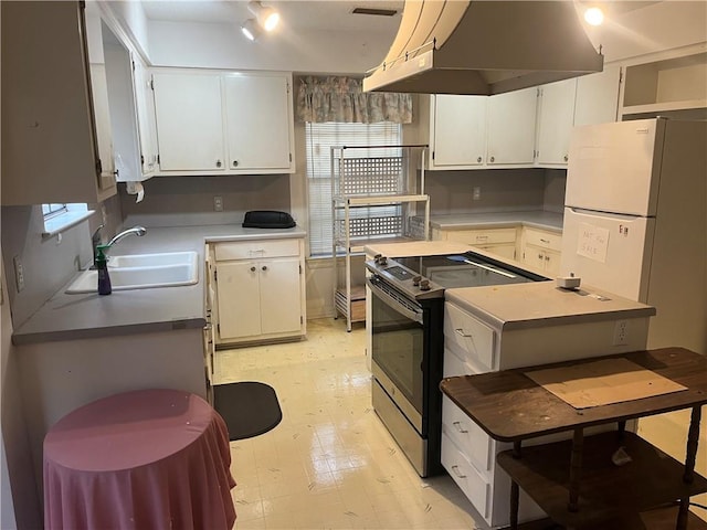 kitchen with sink, stainless steel range with electric cooktop, white cabinets, and island exhaust hood