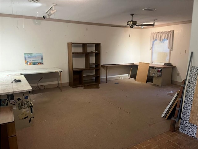 miscellaneous room with ceiling fan and a workshop area