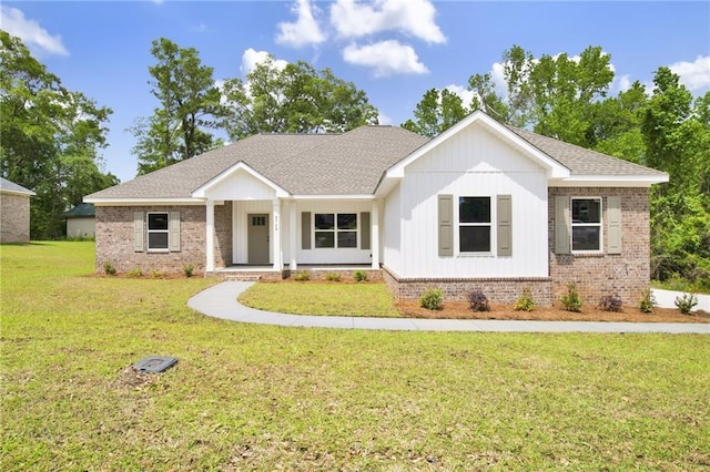 8760 Floyd Crabtree Way, Semmes, AL 36575 - view of front of property featuring brick siding, a front lawn, roof with shingles, and a porch