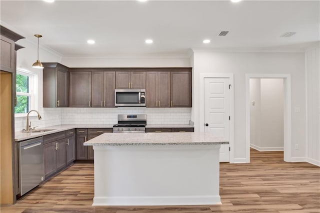 8760 Floyd Crabtree Way, Semmes, AL 36575 - kitchen featuring backsplash, stainless steel appliances, a sink, and dark brown cabinets