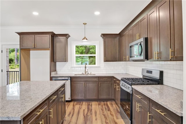 8760 Floyd Crabtree Way, Semmes, AL 36575 - kitchen featuring plenty of natural light, a sink, appliances with stainless steel finishes, and crown molding