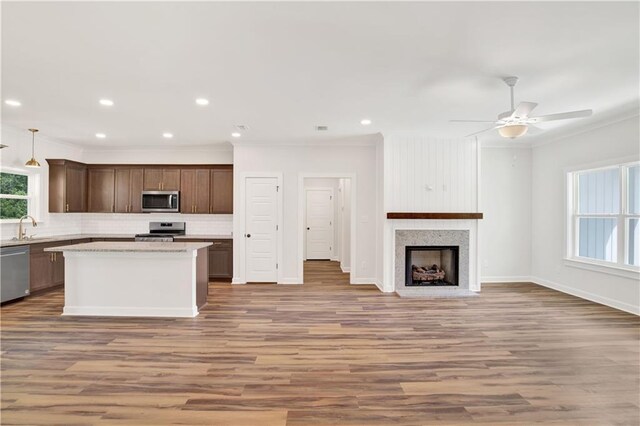 8760 Floyd Crabtree Way, Semmes, AL 36575 - kitchen with ornamental molding, wood finished floors, tasteful backsplash, and stainless steel appliances