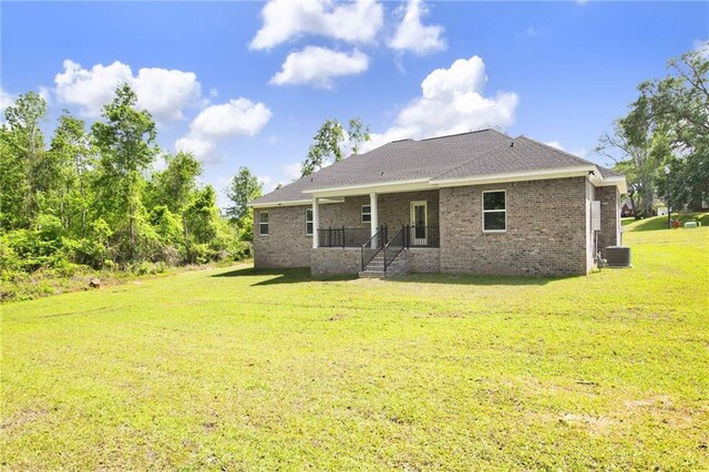 8760 Floyd Crabtree Way, Semmes, AL 36575 - rear view of house featuring a lawn, central air condition unit, and brick siding