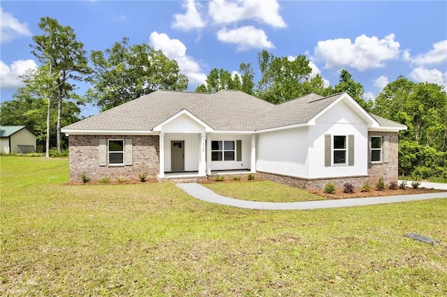 8760 Floyd Crabtree Way, Semmes, AL 36575 - view of front facade featuring brick siding, roof with shingles, a front yard, and a porch