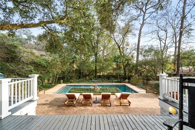 view of pool with a wooden deck and a patio area