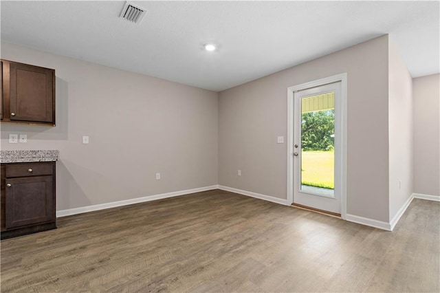 unfurnished dining area with light wood-type flooring