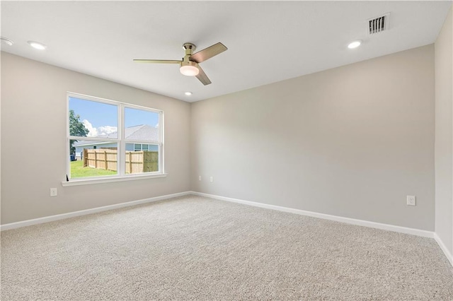 carpeted spare room with ceiling fan