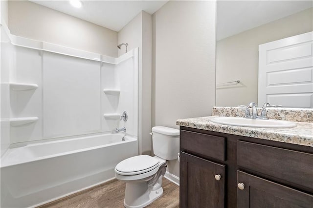 full bathroom with hardwood / wood-style flooring, vanity, toilet, and shower / tub combination