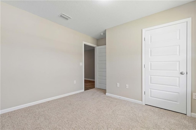 unfurnished bedroom with light carpet