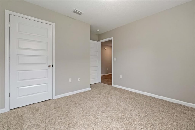 unfurnished bedroom featuring carpet flooring and a closet