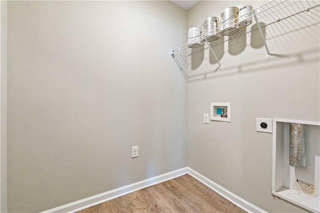 clothes washing area with hookup for an electric dryer, wood-type flooring, and washer hookup