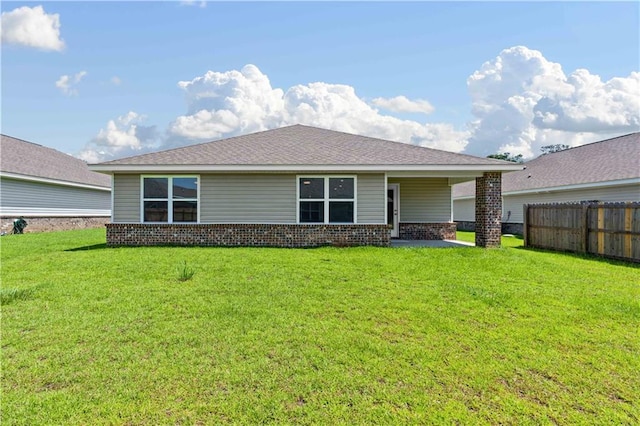 back of house featuring a yard